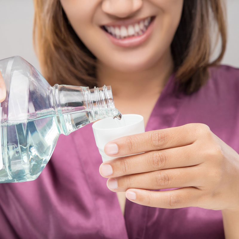 Woman Using Mouthwash After Brushing, Portrait Hands Pouring Mouthwash Into Bottle Cap.